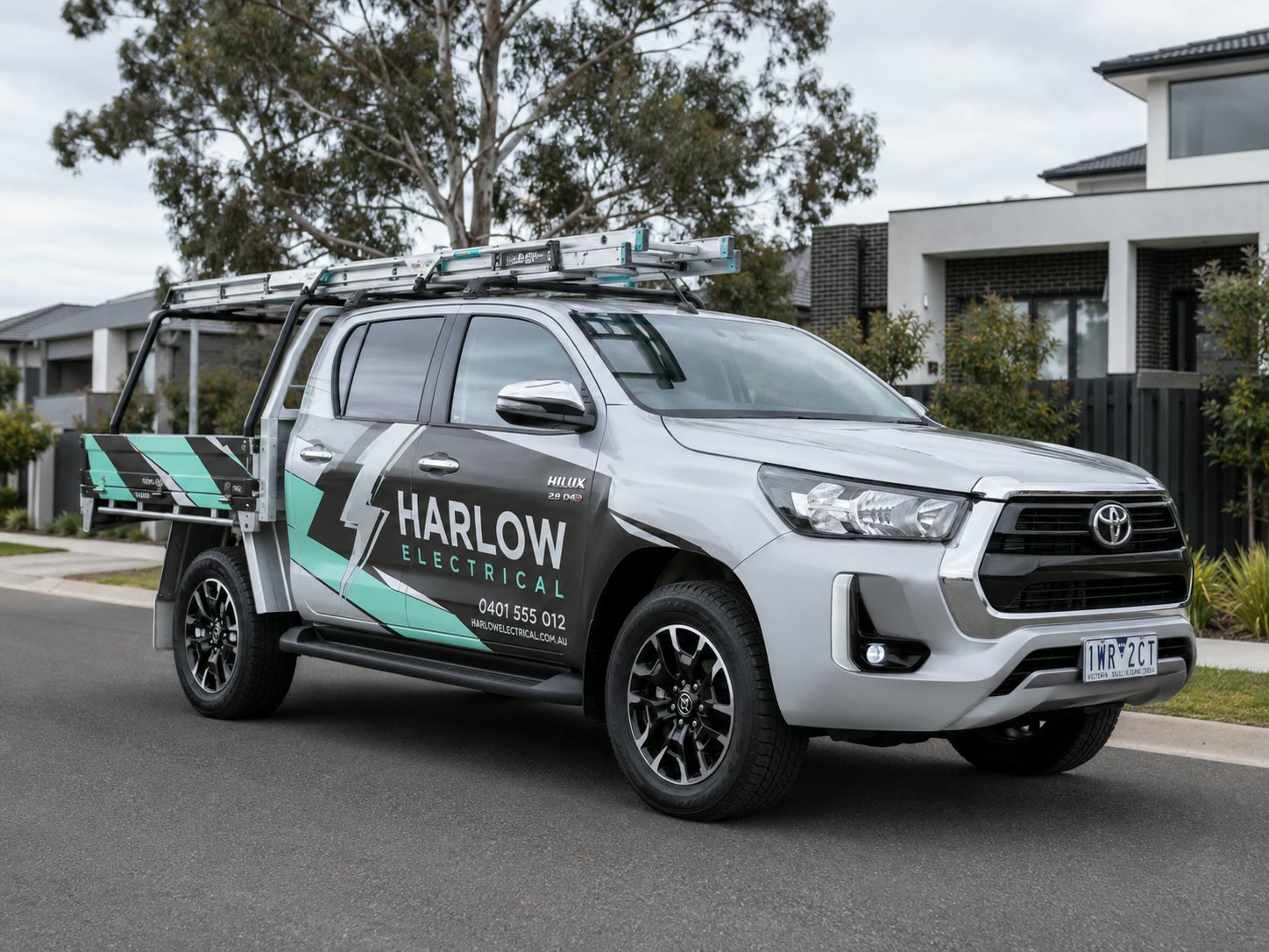 Electrician's ute in full livery, three-quarter front